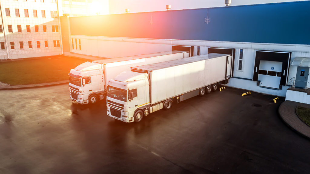 trucks are loaded in a modern logistics centre